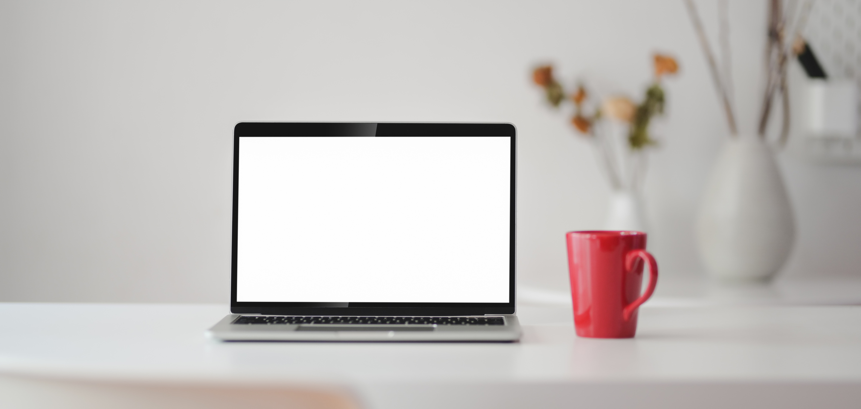 Black and Silver Laptop Computer Beside Red Cup